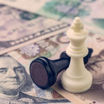 US and China finance trade war concept, black loser and white winner chess king on US dollar and china yuan banknotes, world major market countries