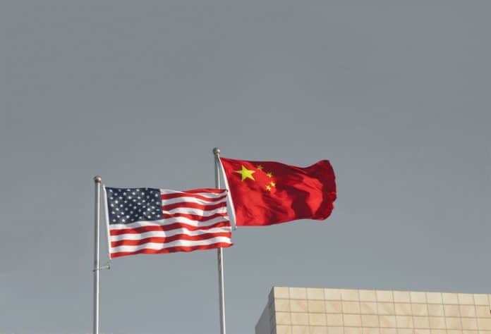 USA and China flags. Trade war economy conflict tax business finance money / United States vs China.
