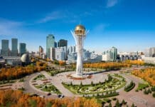 Investing in Kazakhstan’s Agriculture: Seizing New Opportunities Baiterek Tower in Astana, Kazakhstan, rises over a vibrant cityscape with modern skyscrapers and colorful autumn trees
