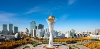 Investing in Kazakhstan’s Agriculture: Seizing New Opportunities Baiterek Tower in Astana, Kazakhstan, rises over a vibrant cityscape with modern skyscrapers and colorful autumn trees