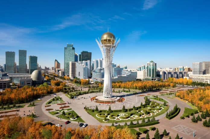 iStock-2177199803 (1) Baiterek Tower in Astana, Kazakhstan, rises over a vibrant cityscape with modern skyscrapers and colorful autumn trees